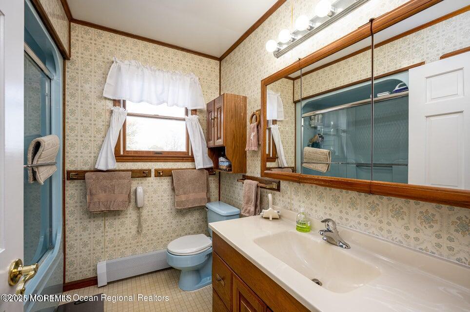 22 Queen Ann Road Brick, NJ 08723 - Photo 22 of 22 a bathroom with a toilet sink and mirror