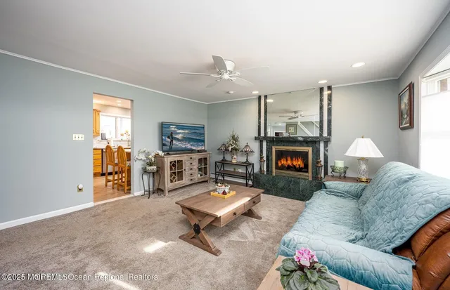 a living room with furniture a fireplace and a flat screen tv