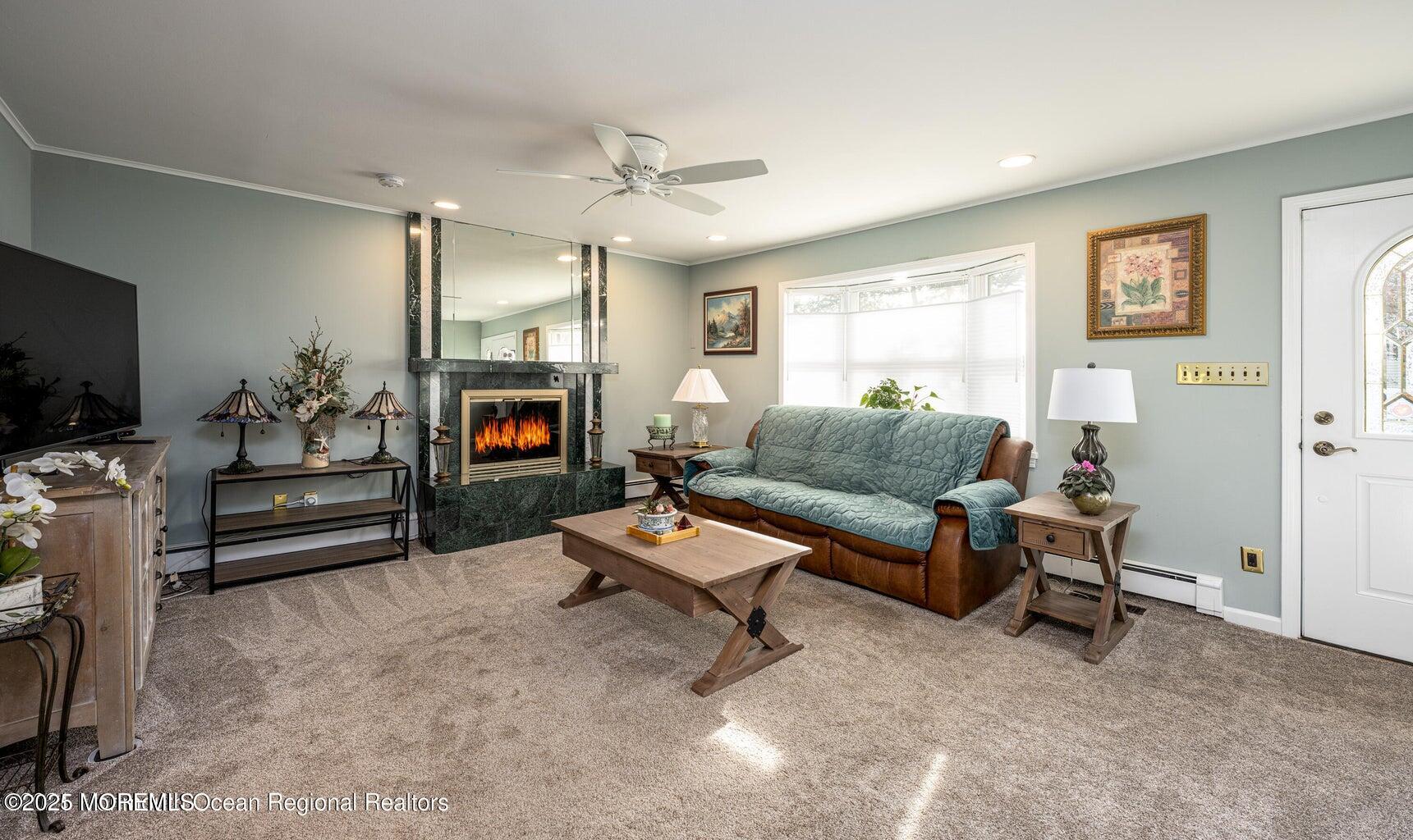 22 Queen Ann Road Brick, NJ 08723 - Photo 7 of 22 a living room with furniture and a flat screen tv with wooden floor