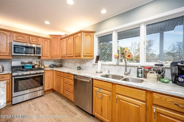 a kitchen with stainless steel appliances granite countertop a sink and cabinets