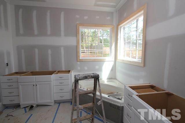 8620 Wapello Lane Raleigh, NC 27613 - Photo 11 of 25 a room that has a dresser and a chair in it