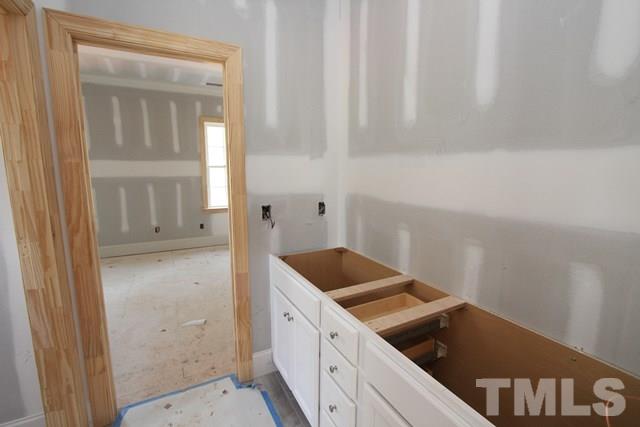 8620 Wapello Lane Raleigh, NC 27613 - Photo 19 of 25 a kitchen with granite countertop white cabinets and a sink