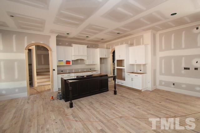 8620 Wapello Lane Raleigh, NC 27613 - Photo 4 of 25 a kitchen with granite countertop a refrigerator and a stove top oven