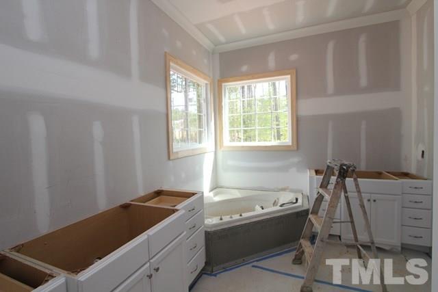 8620 Wapello Lane Raleigh, NC 27613 - Photo 8 of 25 a bath tub sitting in a bathroom next to a window