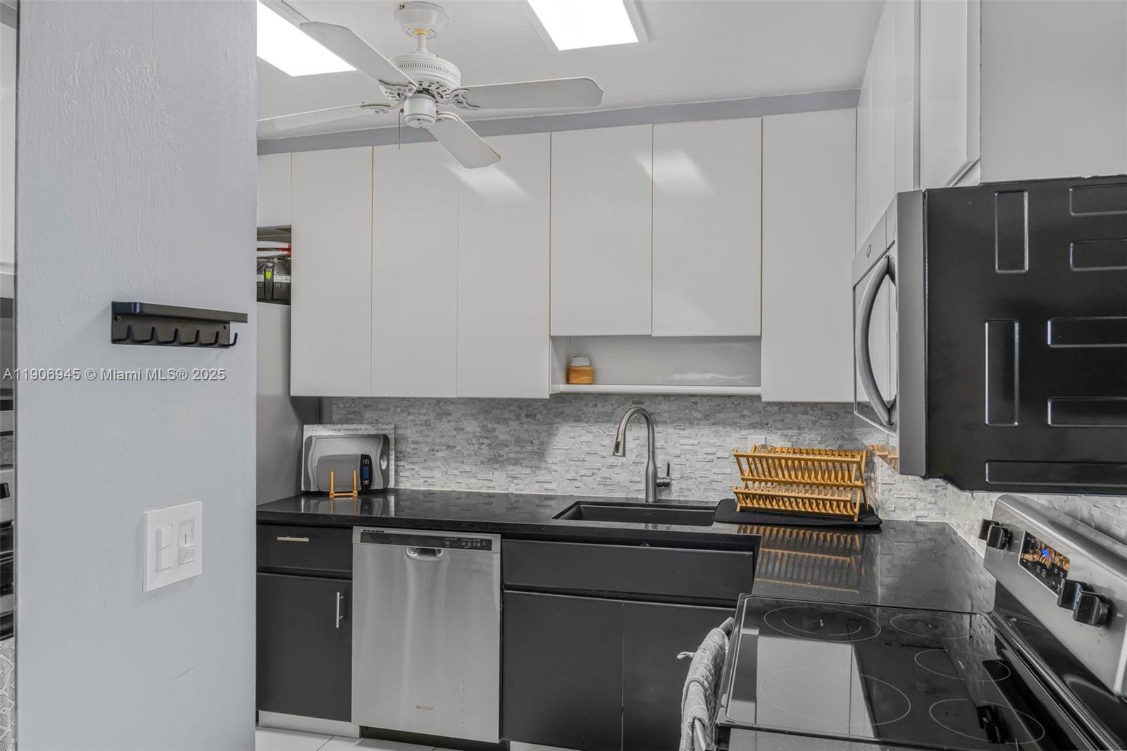 4400 Hillcrest Drive, Unit 912B Hollywood, FL 33021 - Photo 13 of 34 a kitchen with stainless steel appliances granite countertop a sink stove and refrigerator