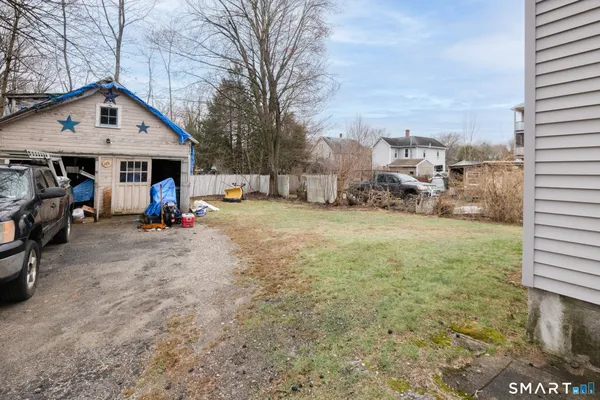 a view of a house with a yard and many windows