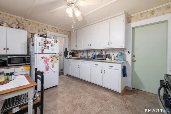a kitchen with refrigerator and cabinets