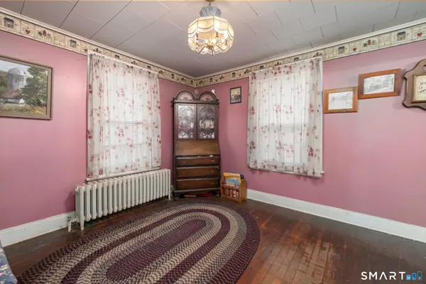 a view of a bedroom with furniture and a window