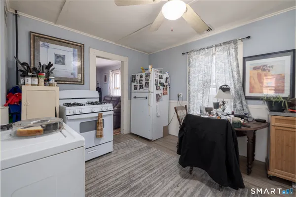a kitchen with a refrigerator and a stove top oven