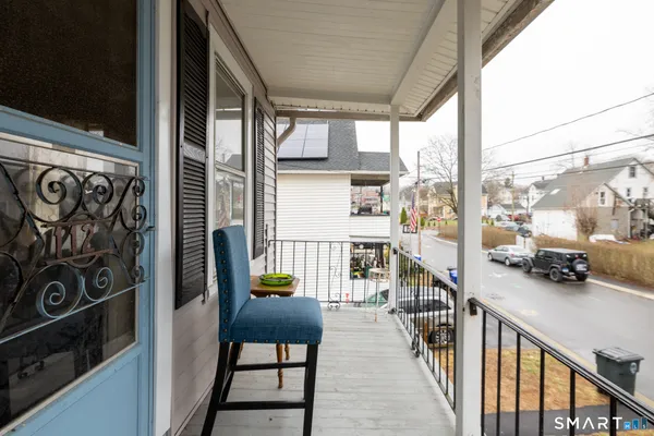 a view of a balcony and car parked