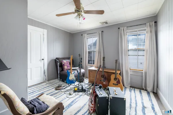 a living room with furniture and wooden floor