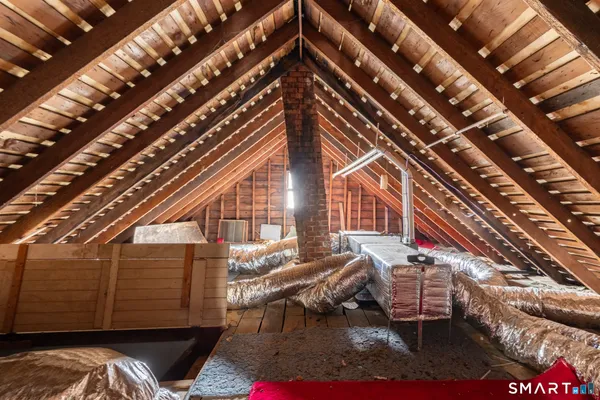 a roof deck with couch and chairs