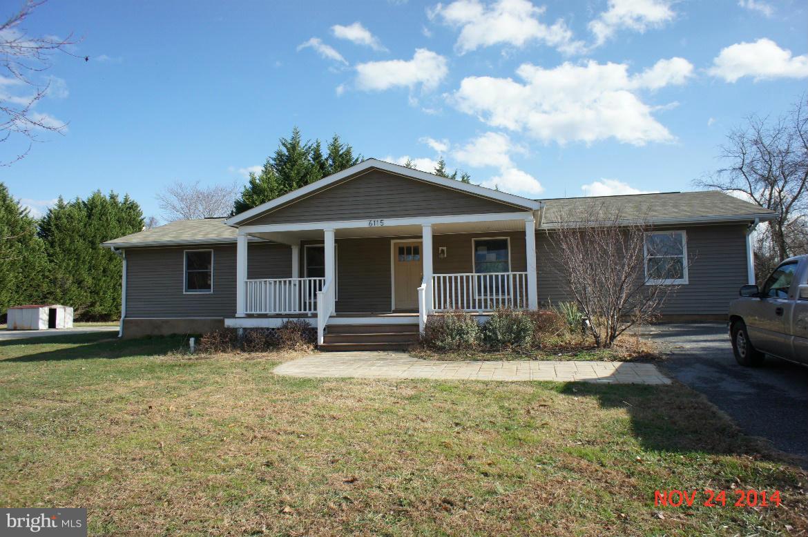 6115 Huntingtown Road Huntingtown, MD 20639 - Photo 1 of 3 a front view of a house with yard patio and fire pit