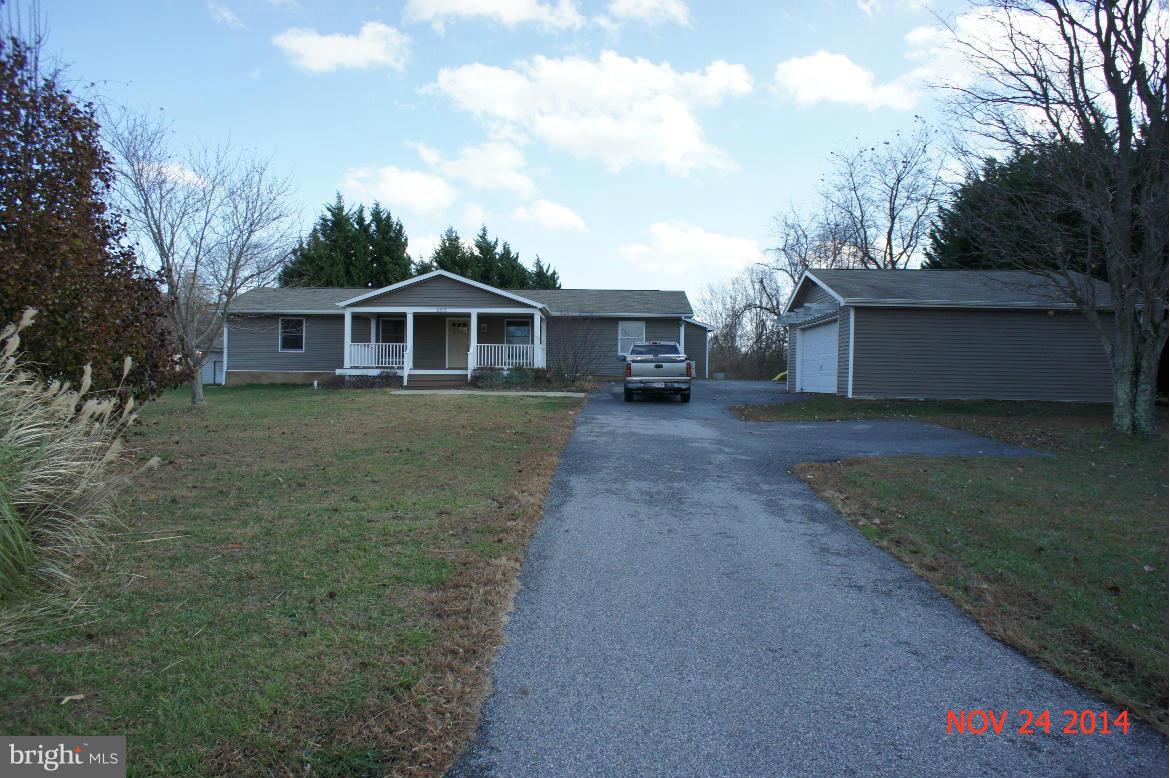 6115 Huntingtown Road Huntingtown, MD 20639 - Photo 2 of 3 front view of a house with a yard