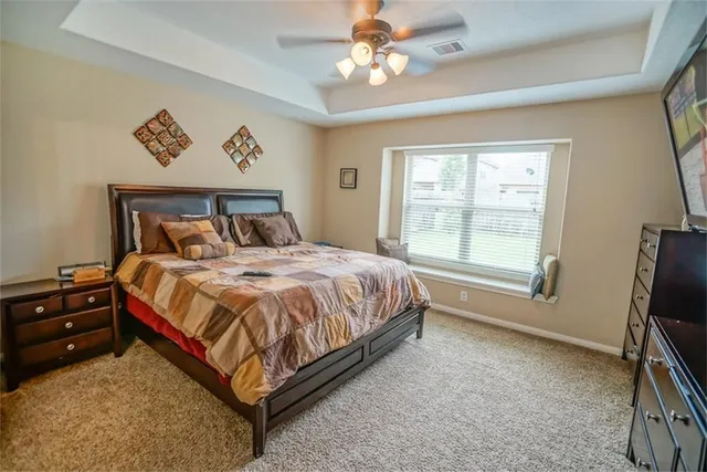 a bed sitting in a bedroom next to a window