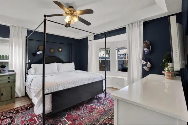 a bedroom with a bed and a chandelier