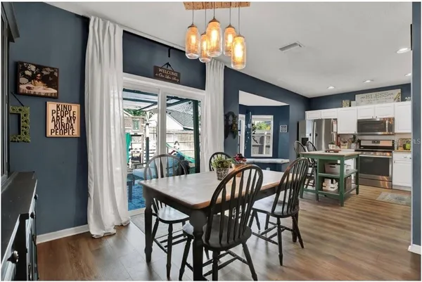 a view of a dining room with furniture wooden floor and chandelier