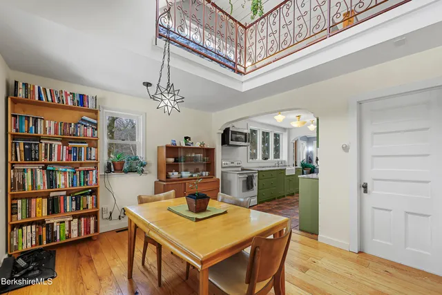 a view of a workspace with furniture and a bookshelf