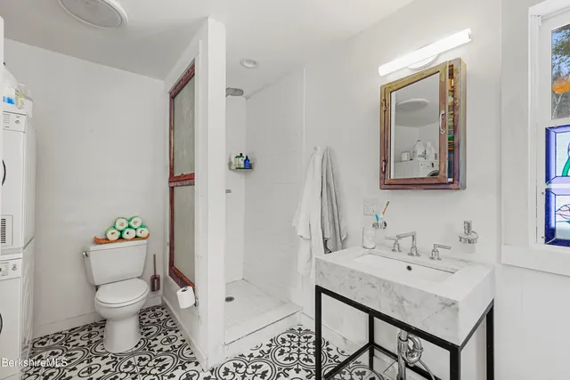 a bathroom with a sink toilet and shower