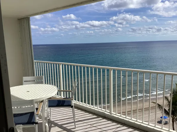 a view of a balcony with wooden floor