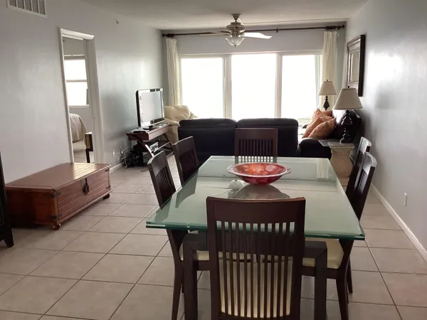a living room with furniture and a lamp
