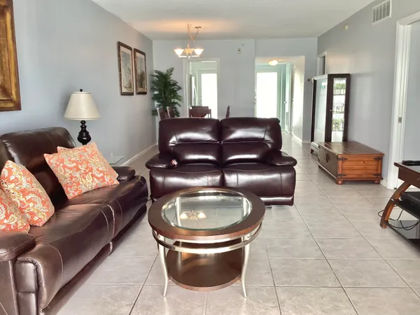 a living room with furniture and a lamp