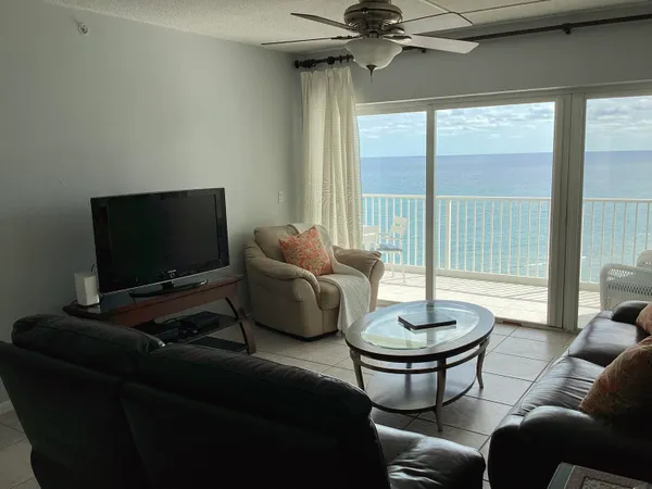 a bedroom with a bed and a flat tv screen on dresser