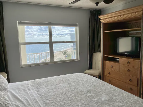 a large bed sitting in a bedroom next to a window