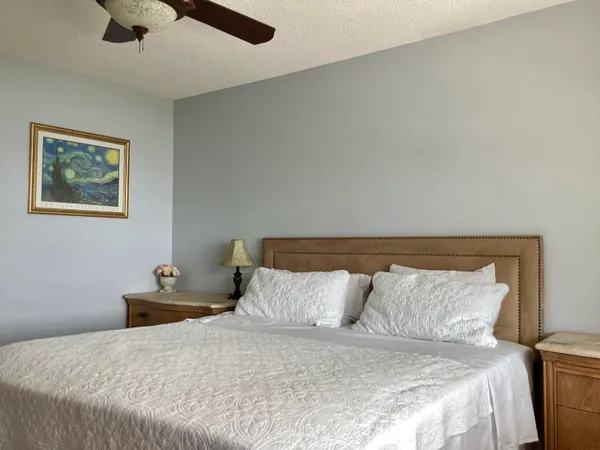 a bedroom with a bed and a mirror