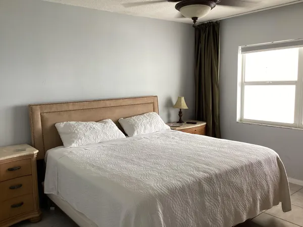 a bedroom with a bed and a flat tv screen in it