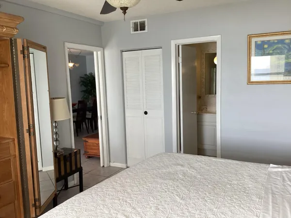a bedroom with a bed and a lamp