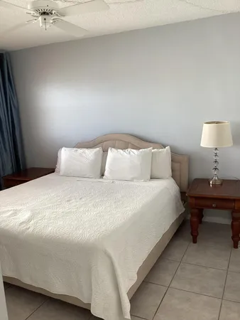a large bed sitting in a bedroom next to a window