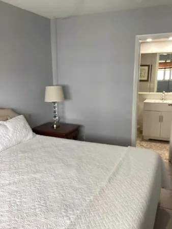 a white toilet sitting next to a shower curtain