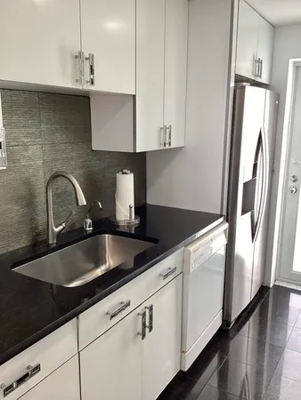 a kitchen with a sink cabinets and window