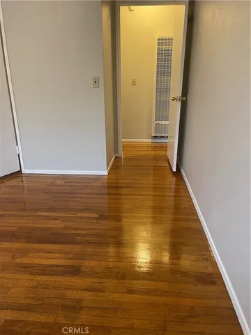 an empty room with wooden floor