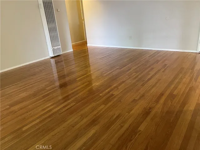 an empty room with wooden floor