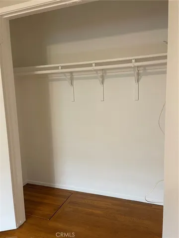 an empty room with wooden floor and door