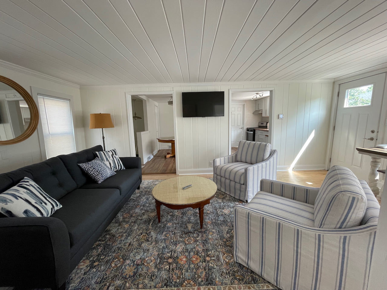 521 Peyton Street, Unit 100 Geneva, IL 60134 - Photo 11 of 34 a living room with furniture a flat screen tv and kitchen view