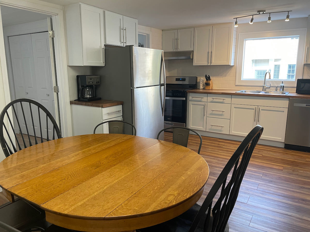 521 Peyton Street, Unit 100 Geneva, IL 60134 - Photo 14 of 34 a kitchen with stainless steel appliances a dining table chairs a refrigerator a stove a sink and dishwasher