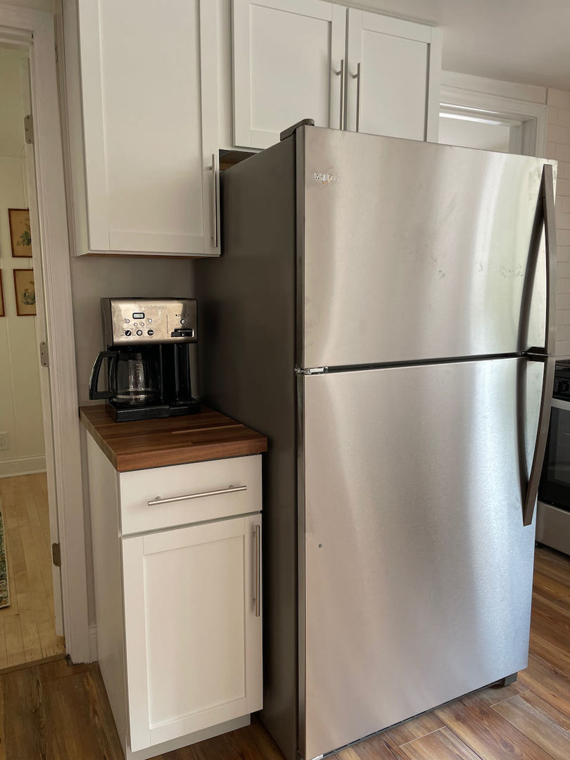 521 Peyton Street, Unit 100 Geneva, IL 60134 - Photo 21 of 34 a white refrigerator freezer and a stove sitting inside of a kitchen