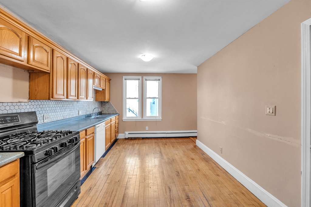 31 Ripley Street, Unit 3 Worcester, MA 01610 - Photo 12 of 29 wooden floor in an empty room with a window