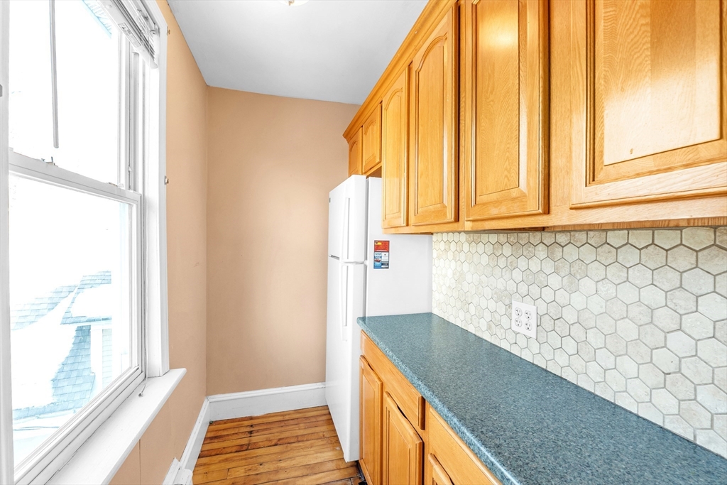 31 Ripley Street, Unit 3 Worcester, MA 01610 - Photo 15 of 29 a view of a hallway with wooden floor and staircase
