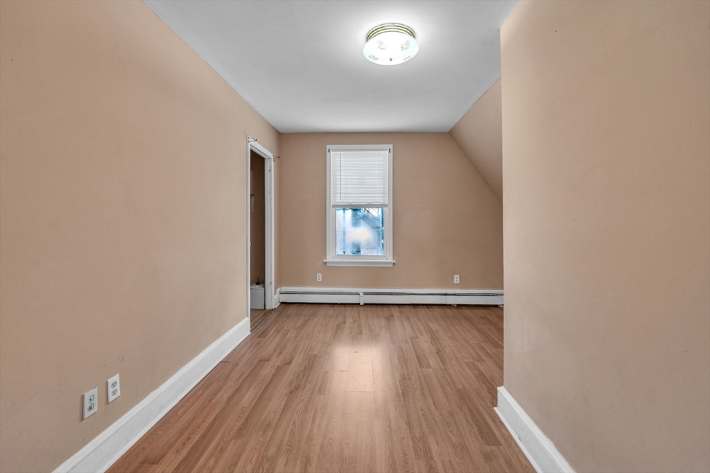 31 Ripley Street, Unit 3 Worcester, MA 01610 - Photo 23 of 29 an empty room with wooden floor and windows