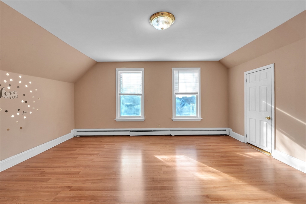 31 Ripley Street, Unit 3 Worcester, MA 01610 - Photo 24 of 29 an empty room with wooden floor and windows