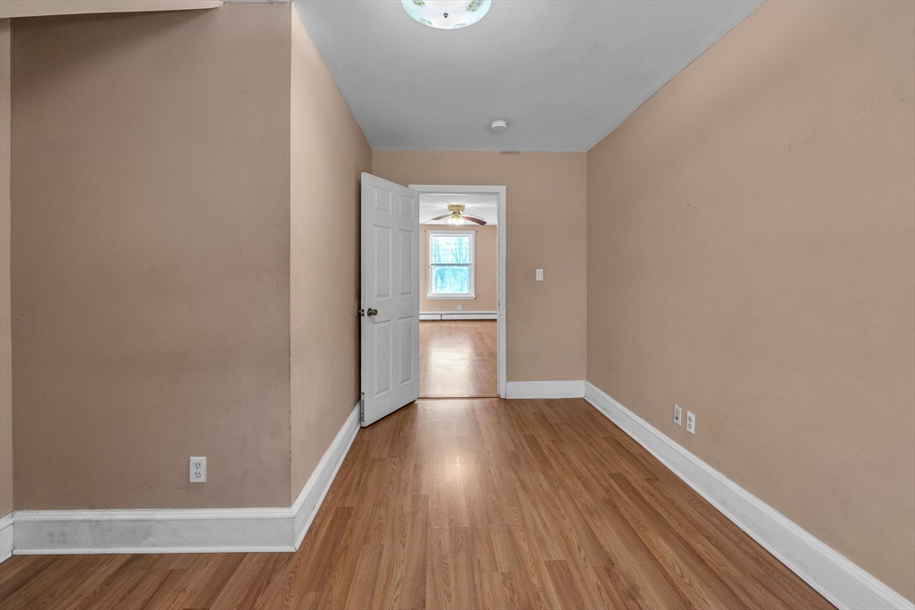 31 Ripley Street, Unit 3 Worcester, MA 01610 - Photo 25 of 29 a view of empty room with wooden floor and fan