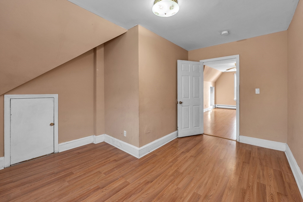 31 Ripley Street, Unit 3 Worcester, MA 01610 - Photo 28 of 29 an empty room with wooden floor and entrance