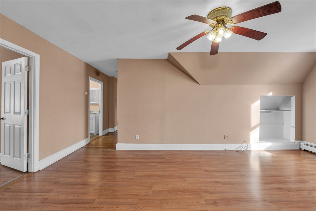 31 Ripley Street, Unit 3 Worcester, MA 01610 - Photo 4 of 29 a view of a big room with wooden floor and a chandelier fan in living room