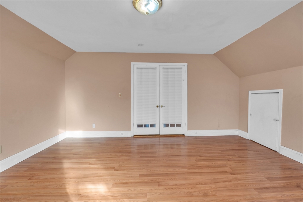 31 Ripley Street, Unit 3 Worcester, MA 01610 - Photo 6 of 29 a view of an empty room with wooden floor and a window