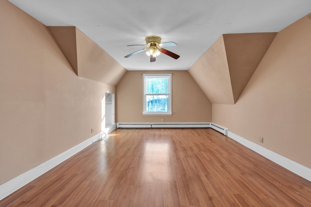 31 Ripley Street, Unit 3 Worcester, MA 01610 - Photo 8 of 29 an empty room with wooden floor chandelier fan and windows