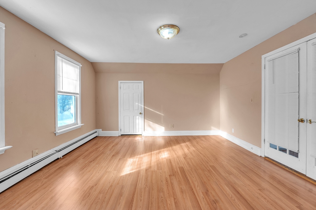 31 Ripley Street, Unit 3 Worcester, MA 01610 - Photo 10 of 29 a view of an empty room with wooden floor and a window